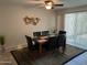 Formal dining room with sliding glass doors, modern ceiling fan, tile floor and seating for six at 10827 W Santa Fe Dr, Sun City, AZ 85351