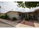 Inviting single-story home with well-manicured landscaping and a charming facade at 10827 W Santa Fe Dr, Sun City, AZ 85351