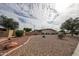 Well-maintained desert landscaping enhances the curb appeal of this single-story home at 10827 W Santa Fe Dr, Sun City, AZ 85351