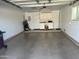Spacious garage with epoxy floors and built-in cabinets at 10827 W Santa Fe Dr, Sun City, AZ 85351