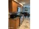 Kitchen features wood cabinets, granite countertops, stainless steel appliances and opens to dining room at 10827 W Santa Fe Dr, Sun City, AZ 85351