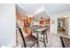 Open concept kitchen area with stainless steel appliances, seating, and access to the bedroom at 10827 W Santa Fe Dr, Sun City, AZ 85351
