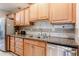 The kitchen boasts wooden cabinets and stainless steel appliances, including a modern dishwasher and a double basin sink at 10827 W Santa Fe Dr, Sun City, AZ 85351