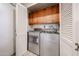 Laundry room with updated appliances and extra cabinet storage at 10827 W Santa Fe Dr, Sun City, AZ 85351