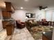 Inviting living room featuring neutral tones, tile floors, and comfortable seating at 10827 W Santa Fe Dr, Sun City, AZ 85351