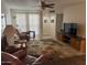Relaxing living room with comfortable furniture, large windows, and tile floors at 10827 W Santa Fe Dr, Sun City, AZ 85351