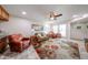 Bright living room featuring comfortable seating, a ceiling fan, and tiled floors at 10827 W Santa Fe Dr, Sun City, AZ 85351