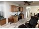View of a built-in desk area, complete with ample storage, adjacent to a sitting area with comfortable leather chair at 10827 W Santa Fe Dr, Sun City, AZ 85351