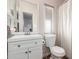 Bathroom featuring a toilet, mirror, vanity, sink, and white cabinets at 10951 N 91St Ave # 222, Peoria, AZ 85345