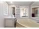 Bathroom featuring a soaking tub, mirrors, and light pink walls at 10951 N 91St Ave # 222, Peoria, AZ 85345