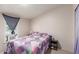 Bedroom featuring a colorful patchwork quilt, a window air conditioner, and a nightstand at 10951 N 91St Ave # 222, Peoria, AZ 85345