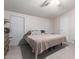 Cozy bedroom with neutral carpet, two windows, and a ceiling fan at 10951 N 91St Ave # 222, Peoria, AZ 85345
