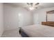 Bedroom showcasing neutral carpet, a ceiling fan, and two doors at 10951 N 91St Ave # 222, Peoria, AZ 85345