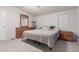 Cozy bedroom with neutral carpet, two windows, and wood dresser and nightstand at 10951 N 91St Ave # 222, Peoria, AZ 85345