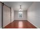 Dining room with a rustic sliding barn door, wood floors, and a chandelier fixture at 10951 N 91St Ave # 222, Peoria, AZ 85345