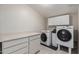 Laundry room equipped with modern washer and dryer units and ample cabinet space at 10951 N 91St Ave # 222, Peoria, AZ 85345