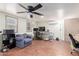 Bright living room with wood floors, comfortable seating, and ceiling fan for comfort at 10951 N 91St Ave # 222, Peoria, AZ 85345