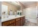 Bathroom featuring a vanity with decorative elements, mirror, and a shower-tub combination at 11402 W Hadley St, Avondale, AZ 85323