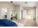 Bright bedroom featuring carpet floors, large windows and stylish decor at 11402 W Hadley St, Avondale, AZ 85323