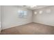 Well-lit bedroom with a large window offering natural light and street views at 11402 W Hadley St, Avondale, AZ 85323