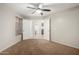 Carpeted bedroom with open doors that reveal an ensuite bathroom, providing convenience and privacy at 11402 W Hadley St, Avondale, AZ 85323