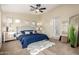 Comfortable bedroom featuring plush carpet, ceiling fan, and ample natural light at 11402 W Hadley St, Avondale, AZ 85323