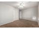 Cozy bedroom with a ceiling fan, closet and carpeted floor offers a comfortable private space at 11402 W Hadley St, Avondale, AZ 85323