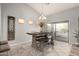 Elegant dining room with modern table setting and natural light from sliding glass doors at 11402 W Hadley St, Avondale, AZ 85323