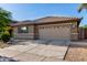 A single-story home features a desert landscape and a convenient two-car garage at 11402 W Hadley St, Avondale, AZ 85323