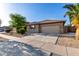 Single-story house featuring a tile roof, desert landscaping, and a spacious two-car garage at 11402 W Hadley St, Avondale, AZ 85323