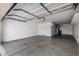 Spacious garage with overhead lighting, offering ample space for vehicles and storage at 11402 W Hadley St, Avondale, AZ 85323