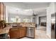 Open concept kitchen with tile flooring, stainless steel appliances, and granite countertops at 11402 W Hadley St, Avondale, AZ 85323