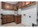Laundry room featuring a sink, wood cabinets, and ample countertop space at 11402 W Hadley St, Avondale, AZ 85323