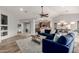 Open-concept living area with tile flooring, blue sofas, and views into the dining space at 11402 W Hadley St, Avondale, AZ 85323