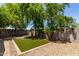 A backyard featuring artificial grass surrounded by gravel and landscaping at 11538 W Windrose Ave, El Mirage, AZ 85335