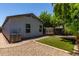An outdoor view showcasing a neat backyard with artificial grass at 11538 W Windrose Ave, El Mirage, AZ 85335