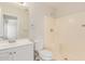 This full bathroom has a shower, vanity, toilet and neutral color scheme at 11538 W Windrose Ave, El Mirage, AZ 85335