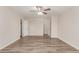Spacious bedroom with wood-look floors, ceiling fan and neutral paint, ready for personalization at 11538 W Windrose Ave, El Mirage, AZ 85335
