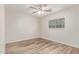 Bedroom features wood-look floors, a ceiling fan, and natural light, providing comfort at 11538 W Windrose Ave, El Mirage, AZ 85335