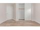 This bedroom features wood-look floors, neutral paint and sliding closet doors for easy storage at 11538 W Windrose Ave, El Mirage, AZ 85335