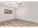 A bright bedroom features wood-look floors and natural light, creating a calm atmosphere at 11538 W Windrose Ave, El Mirage, AZ 85335