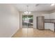 Bright dining room features tile floors, chandelier, view into the backyard, and kitchen access at 11538 W Windrose Ave, El Mirage, AZ 85335