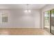 Bright dining room features tile floors, chandelier and access to backyard for seamless entertaining at 11538 W Windrose Ave, El Mirage, AZ 85335