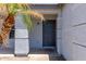 Covered front entryway features a textured wall finish and modern front door at 11538 W Windrose Ave, El Mirage, AZ 85335