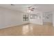 Bright living room features tile floors, a ceiling fan, and view into the kitchen for seamless entertaining at 11538 W Windrose Ave, El Mirage, AZ 85335
