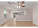 Bright living room features tile floors, a ceiling fan, and view into the backyard for seamless entertaining at 11538 W Windrose Ave, El Mirage, AZ 85335