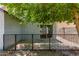 Patio area surrounded by a black fence, gravel and brick border at 11538 W Windrose Ave, El Mirage, AZ 85335