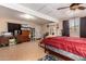 Cozy bedroom featuring a large bed, tile flooring, and a window with natural light at 12423 N 64Th St, Scottsdale, AZ 85254