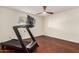 Bedroom featuring a treadmill, wood floor and bright natural light at 12423 N 64Th St, Scottsdale, AZ 85254