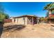 Exterior view of a charming home with a lush yard, pool, and cozy porch at 12423 N 64Th St, Scottsdale, AZ 85254